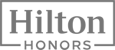 The image shows the "Hilton Honors" logo, featuring bold text in a rectangular frame.